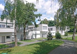 an exterior view of a building with trees at Apartment Słoneczny Gródek 19 Spa & Wellness in Gródek Nad Dunajcem