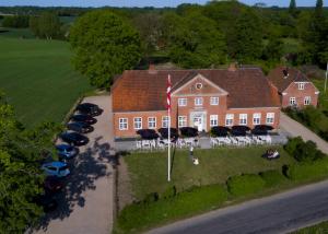 an aerial view of a large house with parked cars at Godstedlund in Øster Ulslev