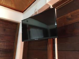 a flat screen tv hanging on a wall at Cabañas MR in Bacalar