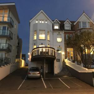 a car parked in a parking lot in front of a building at The White House Hotel in Newquay