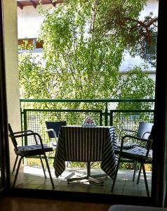 a patio with a table and chairs on a balcony at Apartament Jurata 30 in Jurata