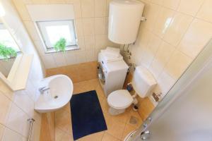 an overhead view of a bathroom with a toilet and sink at Sunset View Apartment in Zadar +21 photos
