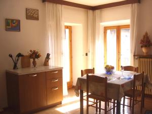a kitchen and dining room with a table and chairs at Casa Bruna Tignale in Tignale