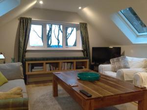 a living room with a couch and a coffee table at Lowood Cottage in Edinburgh