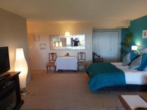 a hotel room with a bed and a television at Davis Bay Bed & Breakfast in Sechelt