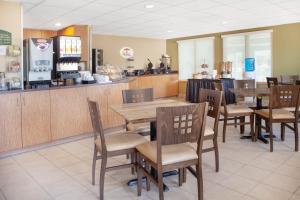 a dining room with tables and chairs in a restaurant at Super 8 by Wyndham Midland in Midland