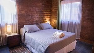 a bedroom with a bed with two towels on it at Hostal Solor in San Pedro de Atacama