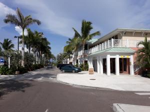a street with a car parked in front of a building at BELL At The Airport Suites - No Smoking & Adults Only - Free Airport Transportation in Nassau