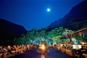 a crowd of people watching a show at night at Silks Place Taroko Hotel in Fushi