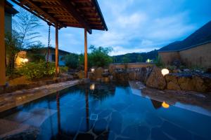 a swimming pool in a backyard at night at Otogitei Kofu in Achi