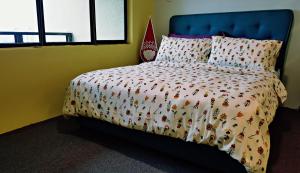 a bedroom with a bed with a comforter with bugs on it at Cempaka Service Suite Unit - PRIVATELY OWNED in Kuala Lumpur