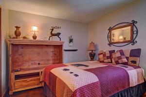 1 dormitorio con cama y espejo en la pared en Gold King Lodge Home, en Breckenridge