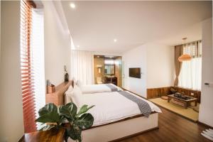 Postel nebo postele na pokoji v ubytování Dali Rong lu Hotel