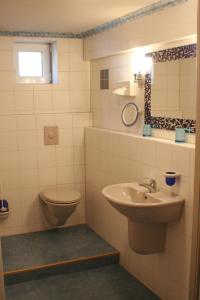 a bathroom with a toilet and a sink at Hotel Rebstock in Rust