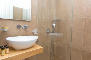 a bathroom with a sink and a shower at Hotel Semeli in Agios Prokopios