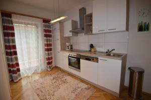 a kitchen with white cabinets and a sink at PirkerHof in Wenischgraben