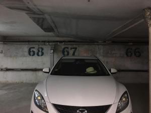 a white car parked in a parking garage at Studios in Complex Elit 4 in Sunny Beach