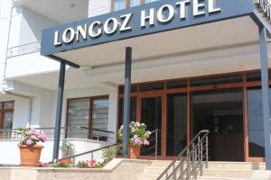 a building with a sign for a hotel at Longoz Hotel in Igneada