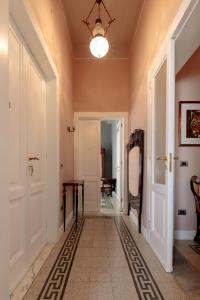 a hallway with orange walls and a ceiling with a chandelier at Talia B&B Guest House in Reggio Calabria