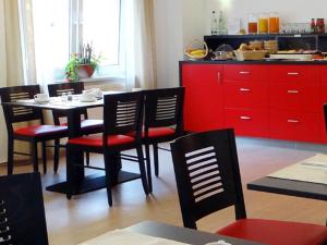 a dining room table and chairs in a kitchen at Hotel 7 Säulen GmbH in Dessau