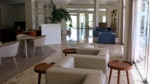 a lobby with couches and tables in a building at Marina Hotel in Ayia Napa
