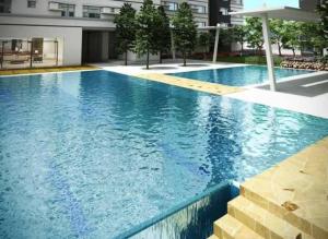 a large swimming pool with blue water in a building at Davao Avida Towers in Davao City