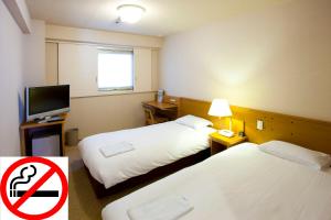 Postel nebo postele na pokoji v ubytování Pearl Hotel Ryogoku