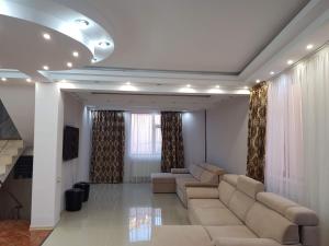 a large living room with couches and curtains at Vila Nicol in Constanţa