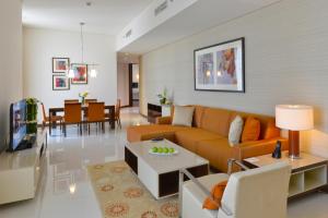 マナーマにあるFraser Suites Diplomatic Area Bahrainのソファとテーブルのあるリビングルーム