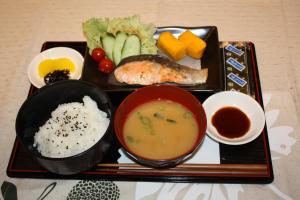 a tray of food with soup rice and vegetables at Hotel Free Style Okayama in Okayama