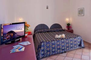 Cama ou camas em um quarto em Hotel Residence S.Angelo