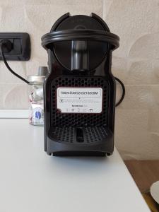 a black coffee pot sitting on a table at Karina House-check in H 24 in Como