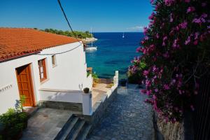 a white house with a view of the ocean at Ostria in Patitiri
