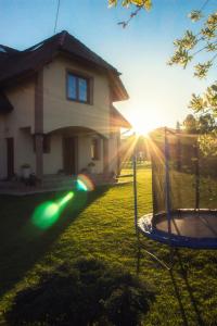 a house with a trampoline in front of a yard at Agroturystyka u Haliny in Kamesznica