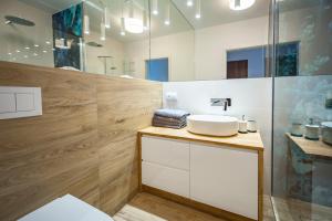 a bathroom with a sink and a mirror at Unique 3City Apartments - Sea Apartment in Gdańsk +11 photos