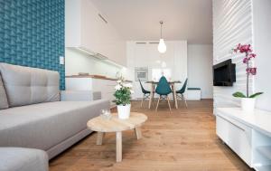 a living room with a couch and a table at Unique 3City Apartments - Sea Apartment in Gdańsk