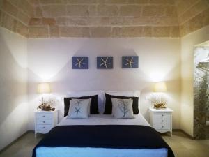 a bedroom with a large bed with two night stands at Casa Carlotta in Monopoli