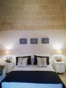a bedroom with a large bed with two night stands at Casa Carlotta in Monopoli
