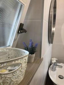 a bathroom with a bowl sink and a window at Apartment Susanj in Mošćenice +66 photos