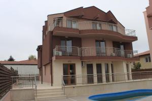a building with balconies and a pool in front of it at Sea & Hill Guest Houses хотелски тип in Lozenets