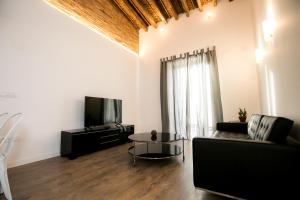 a living room with a couch and a tv at Denia Loft in Denia