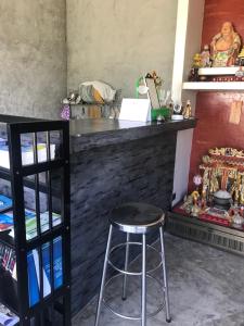 a bar with a stool in front of a counter at La Chambre Boutique @ Ko Lanta in Ko Lanta