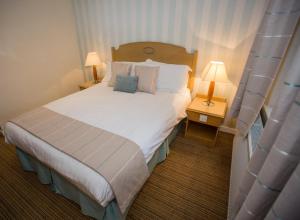 Ένα ή περισσότερα κρεβάτια σε δωμάτιο στο The Manor Guest House