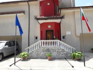 a building with a red door and a flag at Villa Sunny Hill in Fish Fish