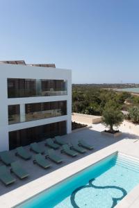 a view of a building with a swimming pool at Sa Pedrera Suites & Spa in Es Pujols