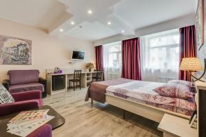 a hotel room with a bed and a living room at Veles Hotel in Saint Petersburg