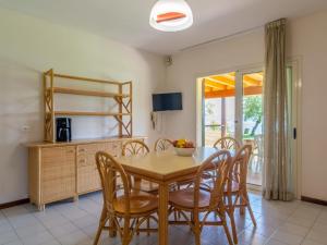 a dining room with a table and chairs at Modern Apartment in Lombardy with swimming pool and garden in Montinelle