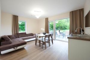 a living room with a couch and a table at Seaside apartments in Palanga