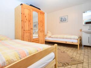 a bedroom with two beds and a mirror at Charming family friendly holiday home with backyard pool in Neukirchen