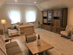 a living room with a piano and a table at Garden View Home in Mārupe
